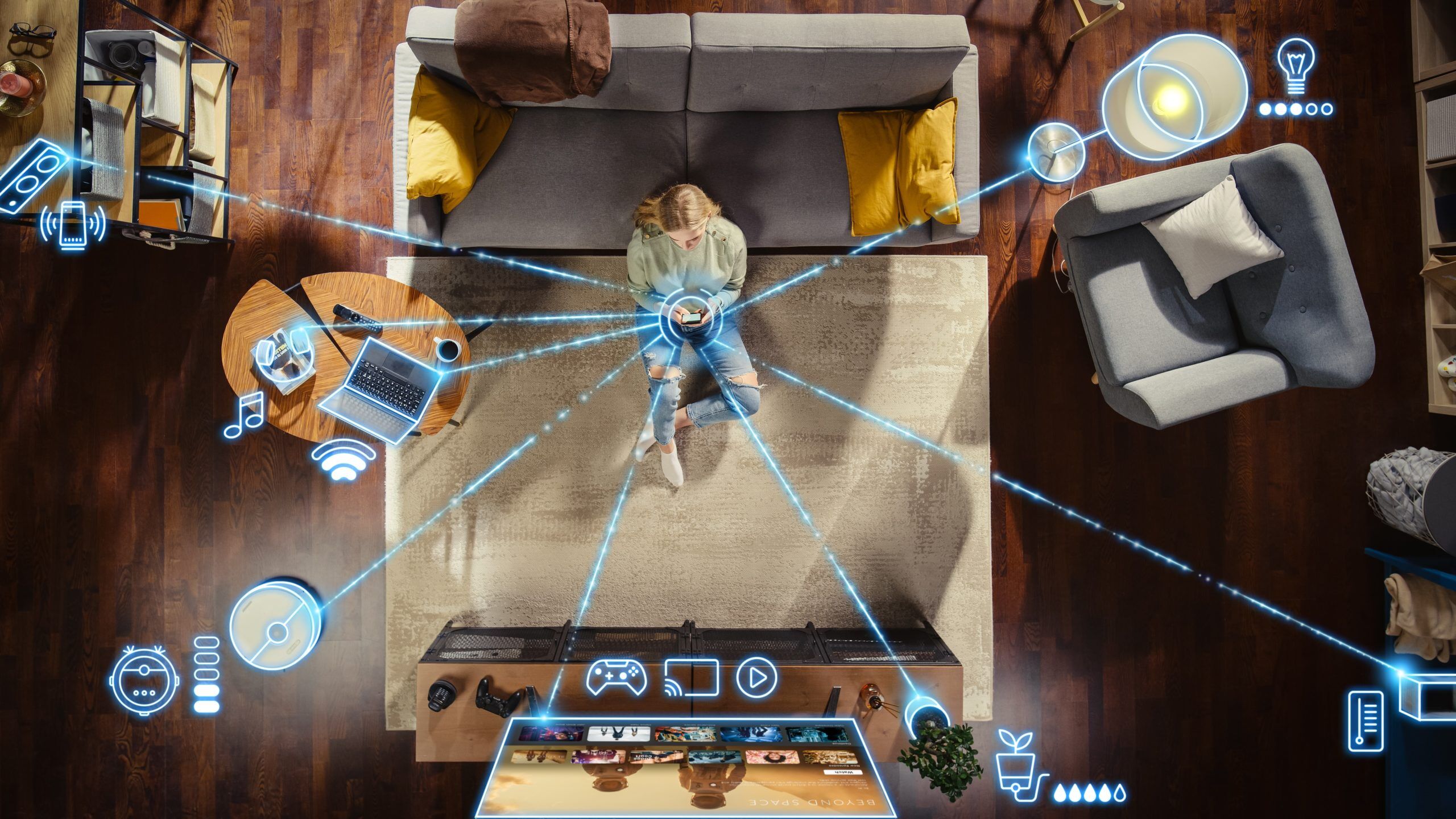 family members of this tech-savvy home sit in the living room controlling various elements of the smart home.
