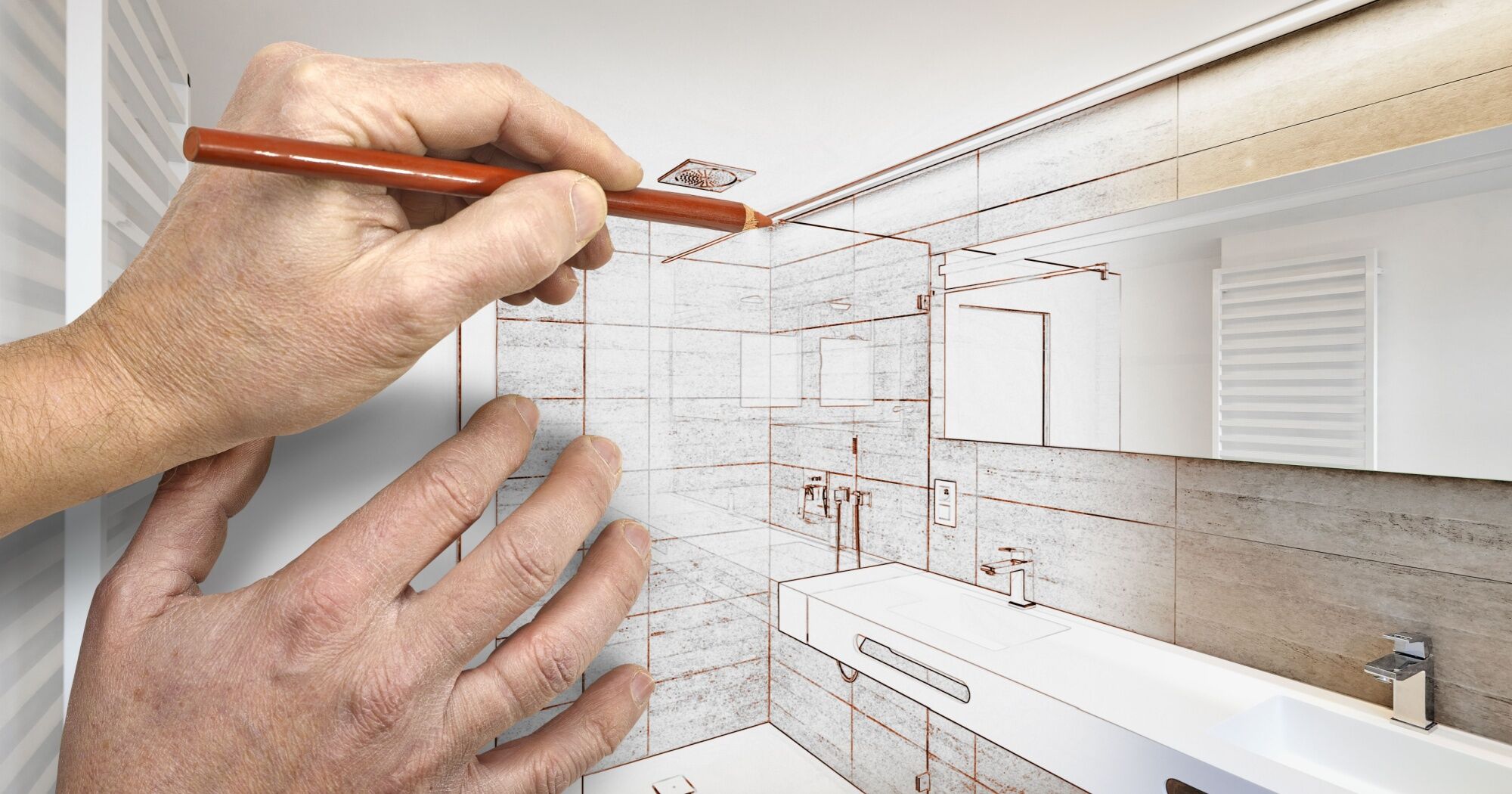 A person drawing out a custom designed modern bathroom with a colored pencil.